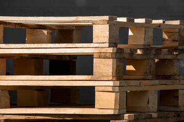A stack of wooden pallets is close