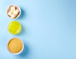 Ingredients cook Kus-Kus on a blue background. Broth, Broth, Butter.Top View Copy space for Text.Flat Lay .Food or Healthy diet concept.
