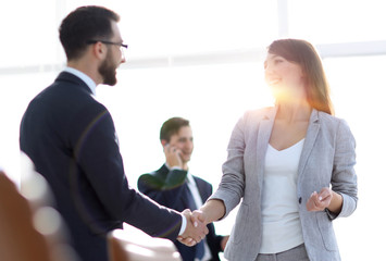 handshake between colleagues in the workplace