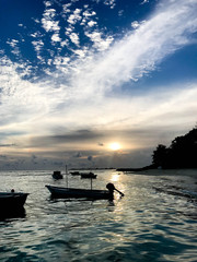 Boat on the water at sunset sunrise