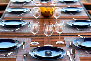Table setting with a wine glasses, cutlery and plates
