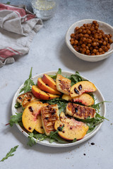 Green salad with grilled halloumi cheese and peaches