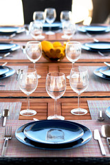 Table setting with a wine glasses, cutlery and plates