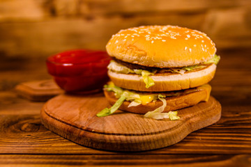 Hamburger and sauce on a wooden table