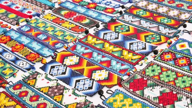 Detail of bracelets of handcrafts made by huichol people in Mexico.