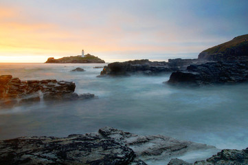 Obraz premium Misty lighthouse at sunrise sunset