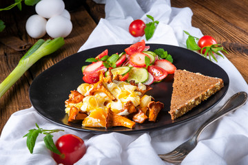 fresh chanterelles with scrambled eggs and a green salad