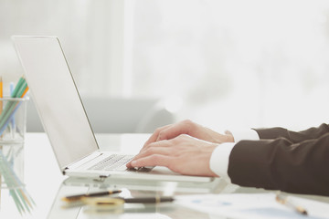 Fototapeta premium Closeup of businessman typing on laptop computer