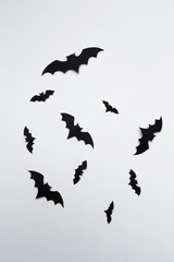 halloween and decoration concept - paper bats flying