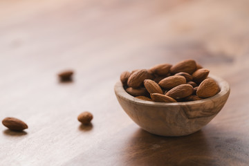peeled almonds in wood bowl