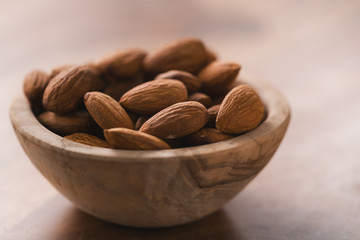 peeled almonds in wood bowl