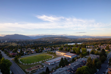 Aerial view of the modern city during a vibrant summer sunset. Taken in Burnaby, Greater Vancouver, BC, Canada.