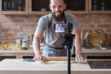 food blogger streaming live. bearded hipster man communicating with subscribers through phone...