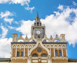 Naklejka premium Fragment of a beautiful old house in Art Nouveau style with sculptures and a clock tower