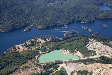 Aerial view of mining industry near Sechelt Inlet during a vibrant sunny day. Located in Sunshine...