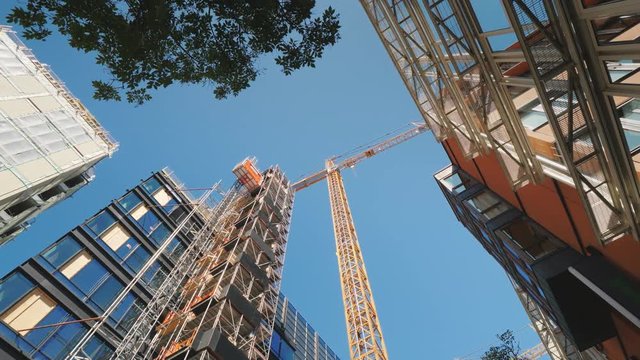 The building is surrounded by glass office buildings. Building and reconstruction in the downtown of the big city