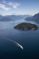 Howe Sound, Vancouver, BC, Canada - July 21, 2018: Aerial view of BC Ferry traveling in the ocean during a vibrant sunny summer day. © edb3_16