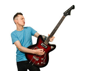 Young guy plays solo on a retro guitar isolated on a white background.