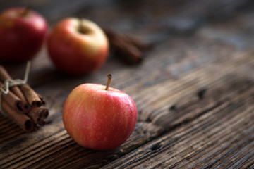 Autumn red apples with cinnamon sticks