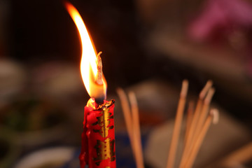 The light of candle and incense on the table food for spirits in Chinese Ghost Festival, focus at the candle