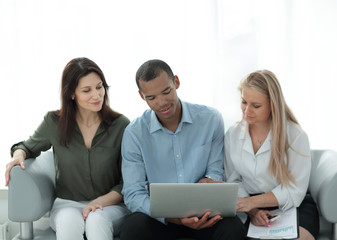 business team working on laptop on the background of the office.