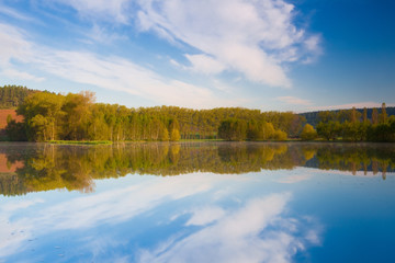 Fototapeta na wymiar Symmetry morning on the pond