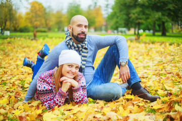 Naklejka na ściany i meble happy young couple in the autumn park
