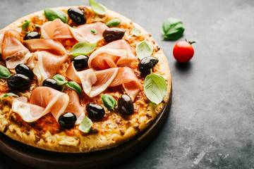 Traditional italian pizza on dark table