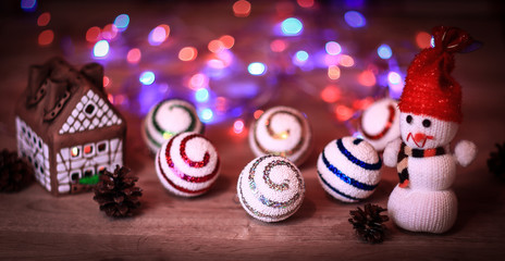 Christmas balls and a toy snowman on Christmas table