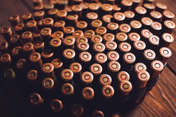 Bullets on wooden background.