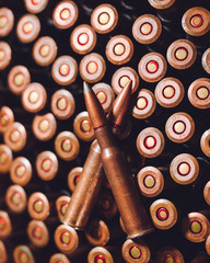 Bullets on wooden background.