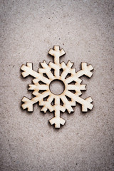 Wooden snowflake on craft paper