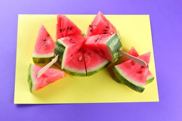 Watermelon pop art. Many pieces of watermelon on a yellow purple background. Natural dessert. Creative story with food for vegetarians. Healthy food