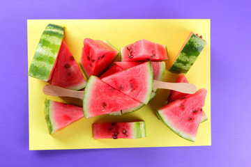 Watermelon pop art. Many pieces of watermelon on a yellow purple background. Natural dessert. Creative story with food for vegetarians. Healthy food