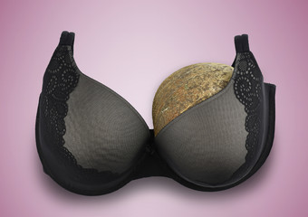 One breast breast cancer concept half empty bra after amputation surgery pink background