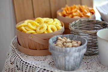  Snacks and pistachios in decorative dishes for candy bar
