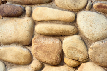 Fototapeta na wymiar close-up view of rough stone wall texture, full frame background
