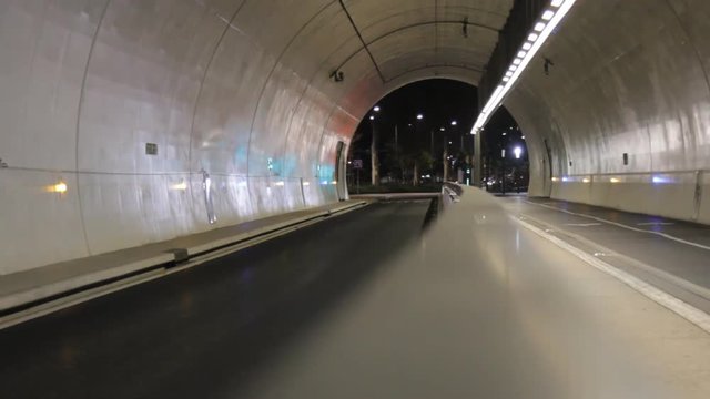 large pedestrian and bus tunnel in Lyon. empty tunnel with cars in the far end
