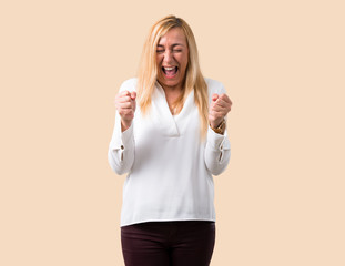 Middle age blonde woman with white shirt annoyed angry in furious gesture. Frustrated by a bad...