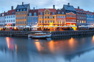 Fototapeta na wymiar Panorama of north side of Nyhavn with colorful facades of old houses and old ships in the Old Town of Copenhagen, capital of Denmark.