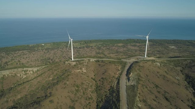 Aerial view of Windmills for electric power production on the seashore. Bangui Windmills in Ilocos Norte, Philippines. Ecological landscape: Windmills, sea in Pagudpud.