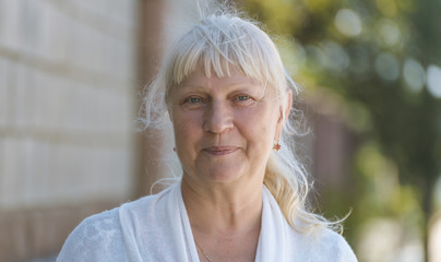 Portrait of a beautiful middle-aged woman outdoors. Selective focus.