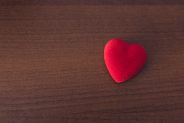 Red heart on a wooden background, concept of medicine or love