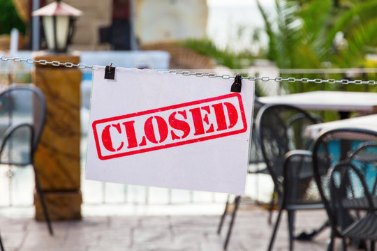 the sign is closed on the chain of a summer cafe