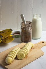 Making banana milk shake with carob and cocoa