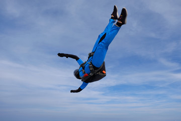 Skydiving. Girl is in the sky.