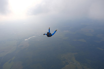 Skydiving. Girl is in the sky.
