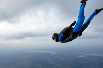 Skydiving. Girl is in the sky.