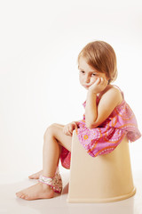 Potty Training. Little cute child girl sitting on a toilet. - obrazy, fototapety, plakaty
