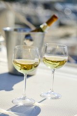 Pair of wineglasses against the yacht